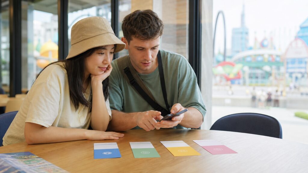Travelers comparing theme park pass options