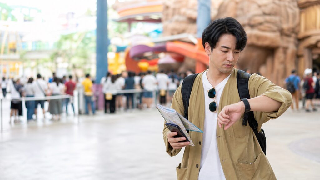 Traveler checking time before theme park rides
